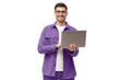 © Damir Khabirov - Young man standing in casual purple shirt, holding laptop and looking at camera with happy smile