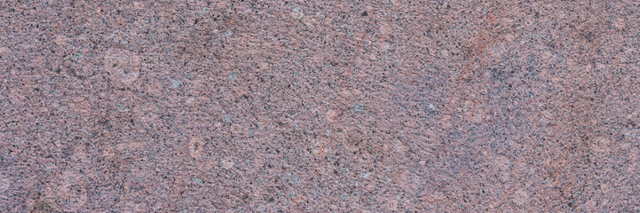 Wall Mural - Granite texture. Natural pink granite with a grainy pattern. Stone background. Solid rough surface of rock. Durable construction and decoration material. Close-up.
