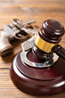 © Freer - angle view gavel and gun and handcuffs at vertical composition