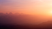 Scenic View Of Silhouette Mountains Against Sky During Sunset