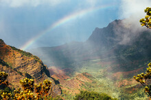 Rainbow And Rain At Kalalau Lookout On The Na Pali Coast On Kauai, Hawaii.