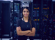 © Tetra Images - Portrait of smiling female technician in server room