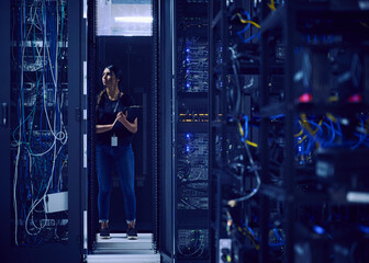 Female technician working in server room