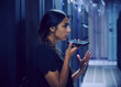 © Tetra Images - Female technician using smart phone in server room