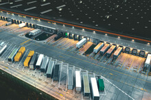 Top View Of Many Trailers And Containers Near The Logistics Warehouse, In The Evening