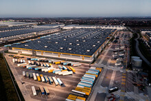 Top View Of Many Trailers And Containers Near The Logistics Warehouse, In The Evening