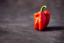 Red Pepper Lies On A Black Table