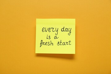 Wall Mural - Note with phrase Every Day Is A Fresh Start on orange background, top view. Motivational quote