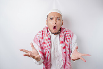 A portrait of a shocked Asian Muslim man isolated by a white background