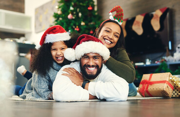 Christmas, portrait and happy family, living room floor and ground, winter celebration and love, care and happiness together. Parents, girl and excited child celebrate festive holidays in home lounge