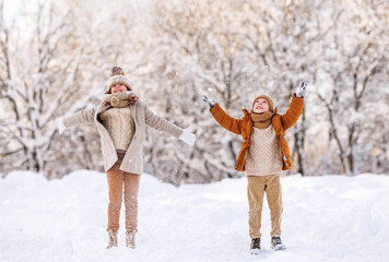 Poster - Happy little kids brother and sister rejoicing first snow in snowy winter park