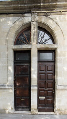 Wall Mural - two high house wooden door entrance brown classic big wood home gate in french city