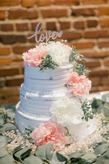 Sticker - Vertical shot of a three-layered wedding cake topped with love text