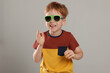 © New Africa - Cute little boy with sunglasses on light grey background