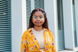© Jose Calsina - Close up portrait of a hispanic serious girl looking at camera isolated outdoors. Headshot of young latin woman with glasses. High quality photo