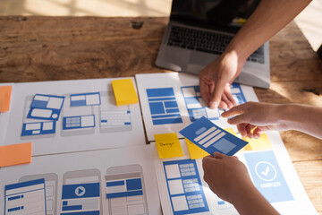 Building and managing a UX team working at desk, UX designers participate in all phases of the UX design.