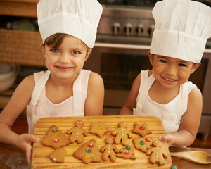 Portrait, girls and Christmas cookies in kitchen, smile and happy for festive, holiday and joy. Xmas, female friends and baking treats together, for celebration and happiness on vacation and break.