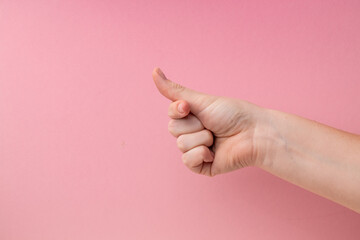 finger heart. Zoomers symbolize love. woman hand showing heart sign on pink background.