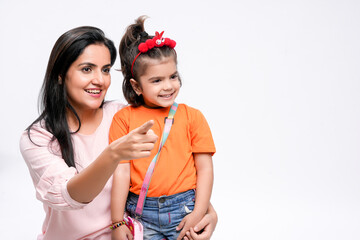 Wall Mural - Indian women with her daughter on white background.