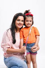 Wall Mural - Indian women with her daughter on white background.