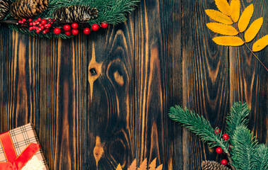 Wall Mural - Christmas wooden background with fir branches and a place to copy.