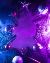 Christmas Layout With Christmas Tree Branches, Christmas Decorations In Vibrant Neon Glow. Copy Space. Top View. Flat Lay