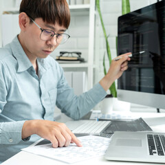male programmer is programming to develop program app and website of corporate while working to chec