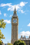 Fototapeta Londyn - The famous Big Ben clock tower against a blue sky in London, England	
