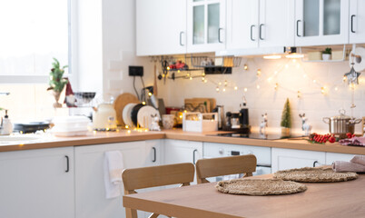 Wall Mural - Festive Christmas decor and mess in the light kitchen, festive breakfast, white scandi interior. New Year, mood, cozy home 