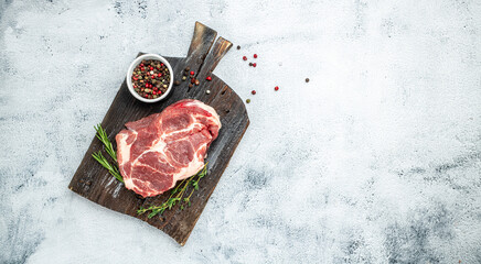 Wall Mural - Pork steak with rosemary and pepper on a light background. Long banner format. top view