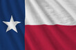 Texas US state flag with big folds waving close up under the studio light indoors. The official symbols and colors in banner