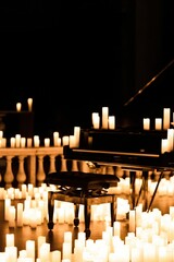 Wall Mural - chair and piano in a dark room surrounded by candles