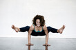 P{photographs of advanced yoga postures demonstrated by a professional teacher in studio. 