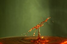 Droplets In Orange Water With Blurry Background