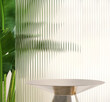 © myboys.me - Modern, minimal round silver colored steel table podium with banana tree and reeded glass partition in dappled sunlight on cream colored wall for luxury, organic, beauty, cosmetic product display
