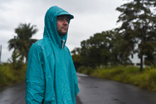 Depressive Concept With Lonely Man In Raincoat Standing On Wet Road Under Rain Close Up Isolated
