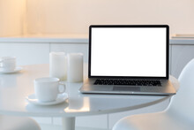 Laptop With Blank Screen On White Table. Home Interior Or Office Background