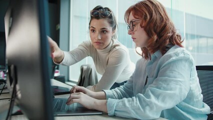 business women having a discussion and working on a code. female programmers collaborating on a soft