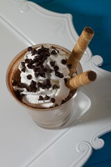 Poster - Closeup of Frappe de chocolate Blanco ice cream on a white tray on top of a table.