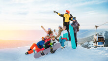 Team Winter Sports Skiers And Snowboarders With Sun Light. Concept Travel Ski Resort With Group Of Friends
