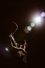 Man Playing On Electric Guitar In The Dark