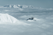 Snow Covered Mountain Peaks Through The Clouds In Austrian Alps, Gastein, Salzburg, Austria