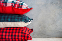 Close-up Of A Stack Of Assorted Pillows With Various Checked Patterns On A Shelf