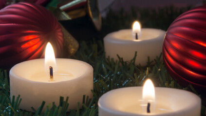 Wall Mural - image with three lighted candles and christmas ornaments