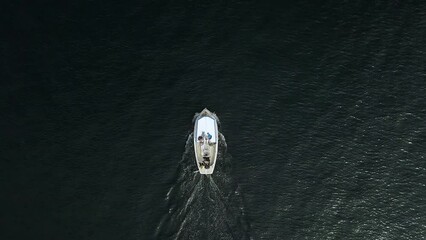 Sticker - Aerial footage above a white boat sailing in peaceful deep blue water in Sweden in daylight