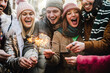 canvas print picture - Group of young people celebrating new year eve with fireworks