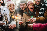 Group of young people celebrating new year eve with fireworks