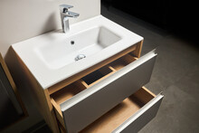 Solutions For Placing Things In Bathroom Horizontal Sliding Pull Out Drawer Shelves Storage In A Cupboard Under Stoneware Washbasin Cabinet Under Sink And Faucet. Modern Loft Flat Minimalistic Design.