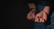 © zwiebackesser - Arrested man in handcuffs as a symbol of сrime and destructive antisocial behavior. Selective focus. Copy space for text