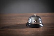 Service Bell On The Wooden Table.